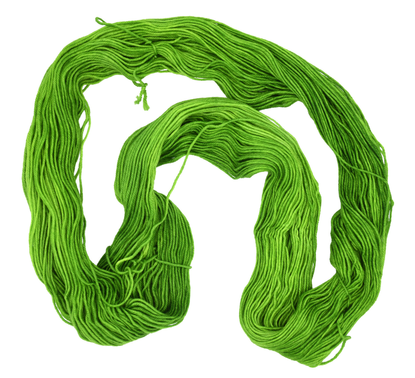 An unfolded skein of Barn Yarn hand-dyed DK weight yarn in colorway Envy - a vibrant avocado green shade, perfect for bold knitting and crochet projects.