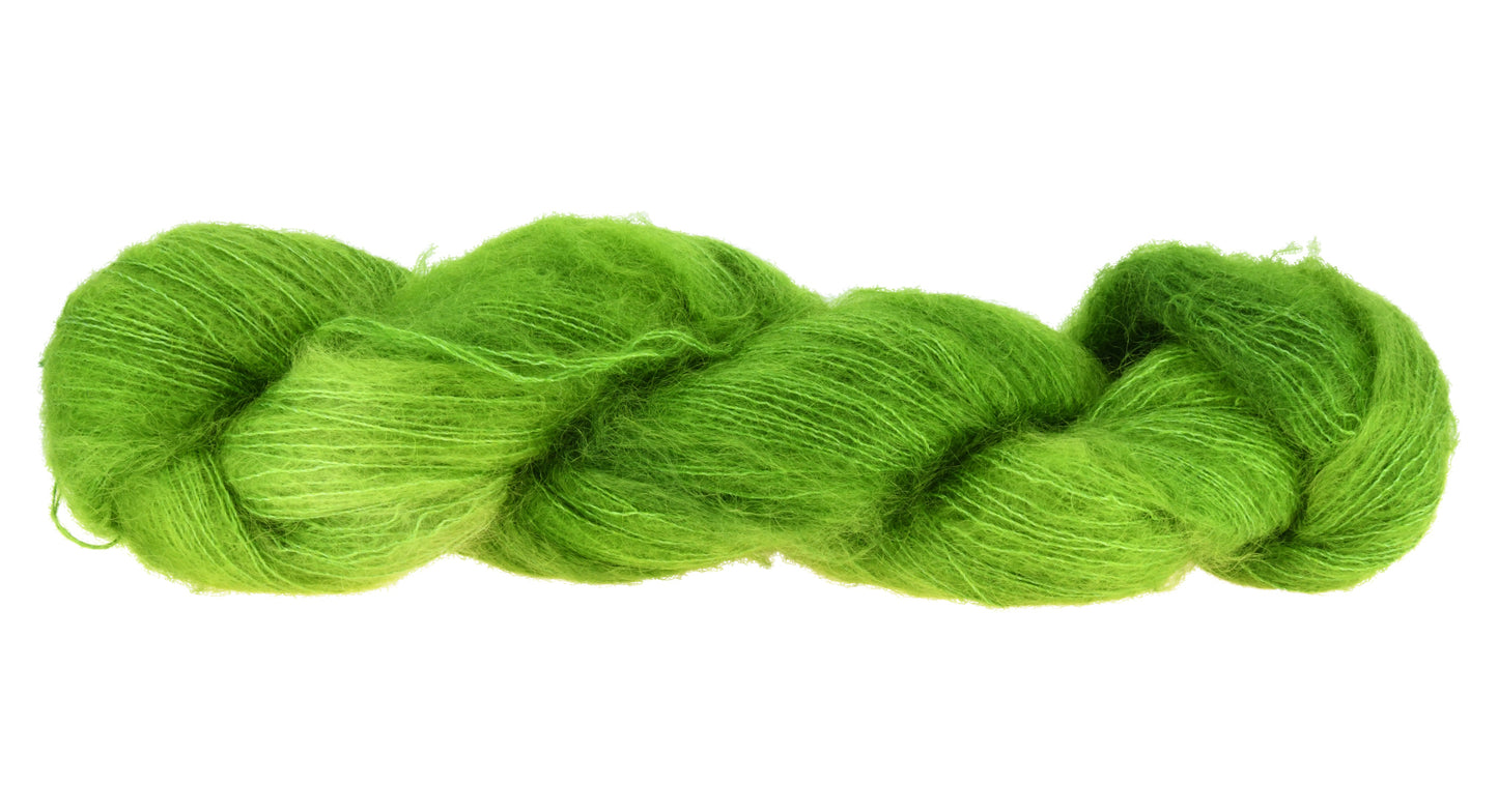 A twisted skein of Barn Yarn hand-dyed mohair yarn in colorway Envy - a vibrant avocado green shade, perfect for bold knitting and crochet projects.