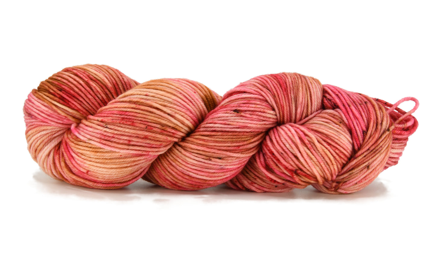 A twisted skein of Barn Yarn hand-dyed DK weight yarn in colorway Poolside Popsicle featuring bright strawberry pink, vanilla and chocolate sprinkles, perfect for knitting and crochet projects.
