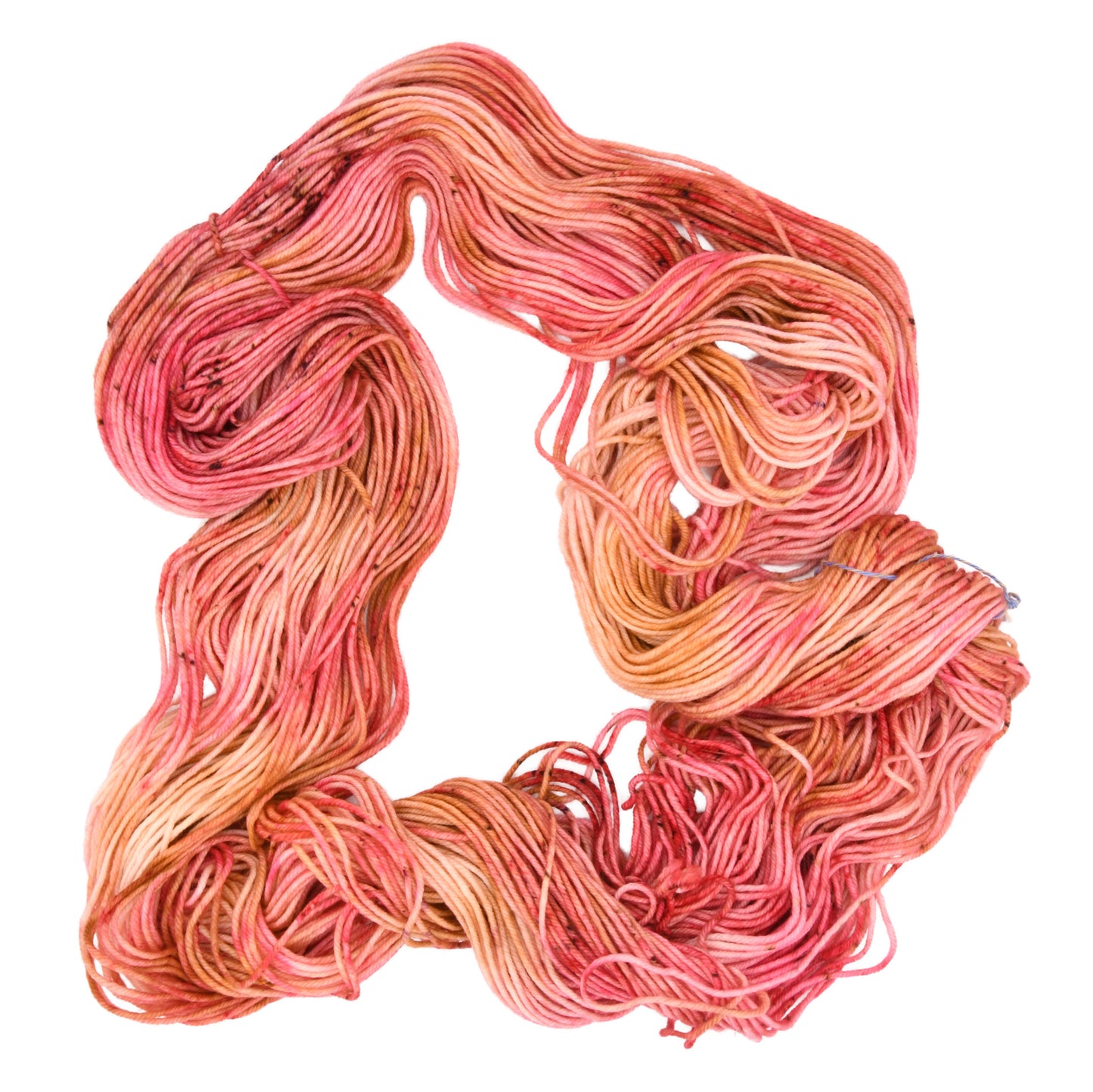 An unfolded skein of Barn Yarn hand-dyed DK weight yarn in colorway Poolside Popsicle featuring bright strawberry pink, vanilla and chocolate sprinkles, perfect for knitting and crochet projects.