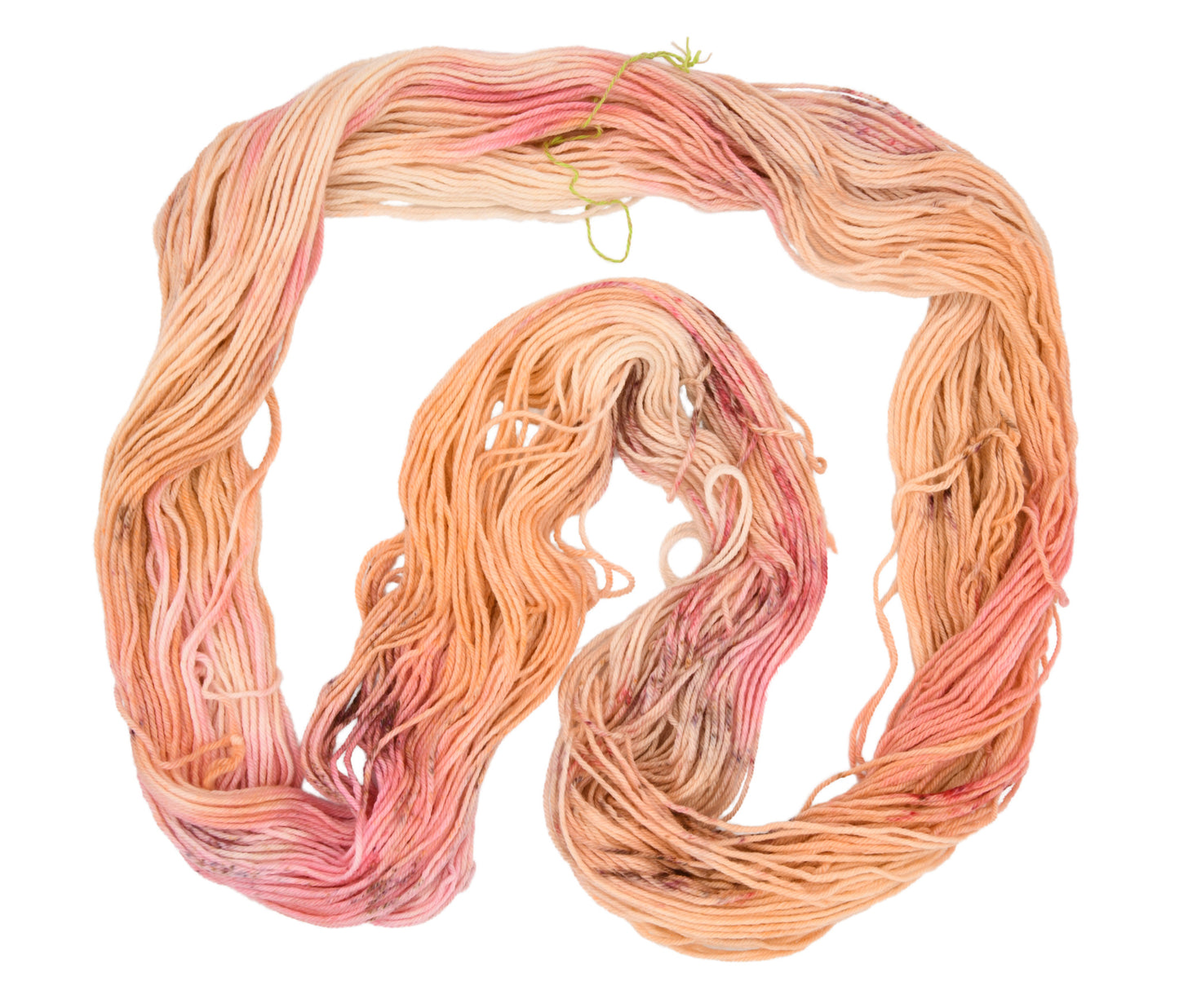 An unfolded skein of Barn Yarn hand-dyed worsted weight yarn in colorway Poolside Popsicle featuring bright strawberry pink, vanilla and chocolate sprinkles, perfect for knitting and crochet projects.