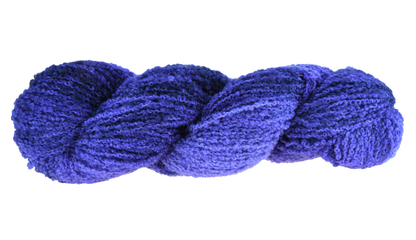 A twisted skein of Barn Yarn boucle DK weight yarn in colorway Lavender; inspired by the lavender flower, perfect for knitting and crochet projects.