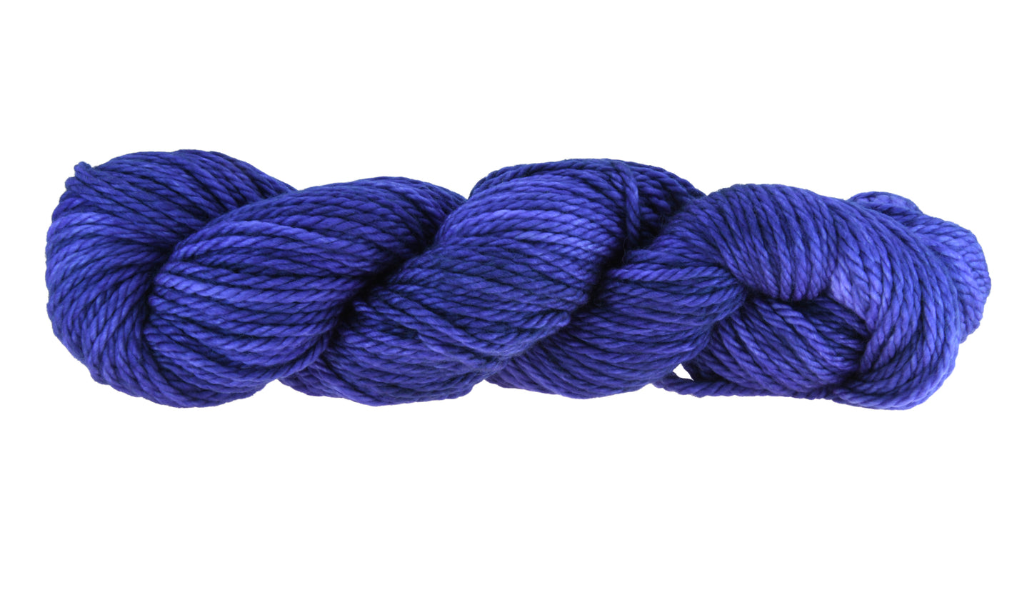 A twisted skein of Barn Yarn bulky weight yarn in colorway Lavender; inspired by the lavender flower, perfect for knitting and crochet projects.