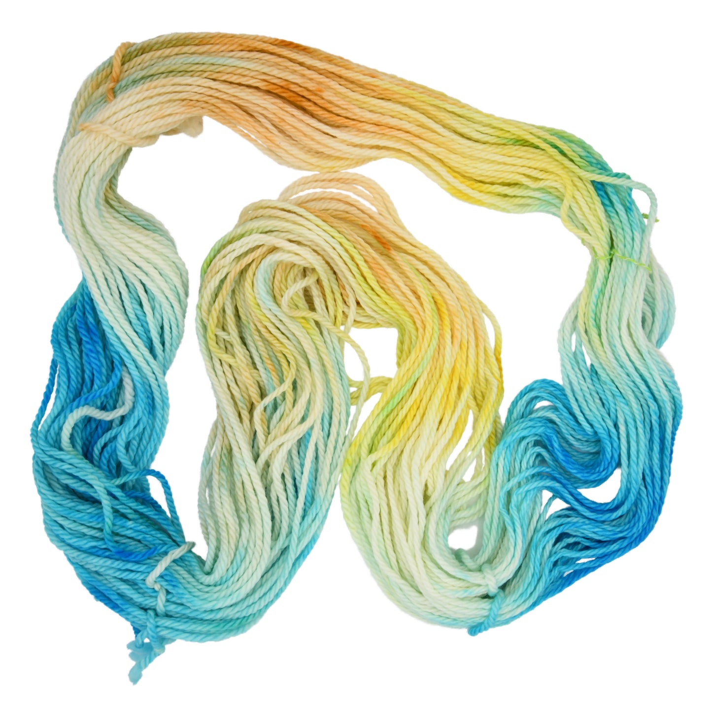 An unfolded skein of Barn Yarn hand-dyed bulky weight yarn in colorway Down by the Seaside with breezy blues, sandy neutrals, and sea-glass greens, perfect knitting and crochet.