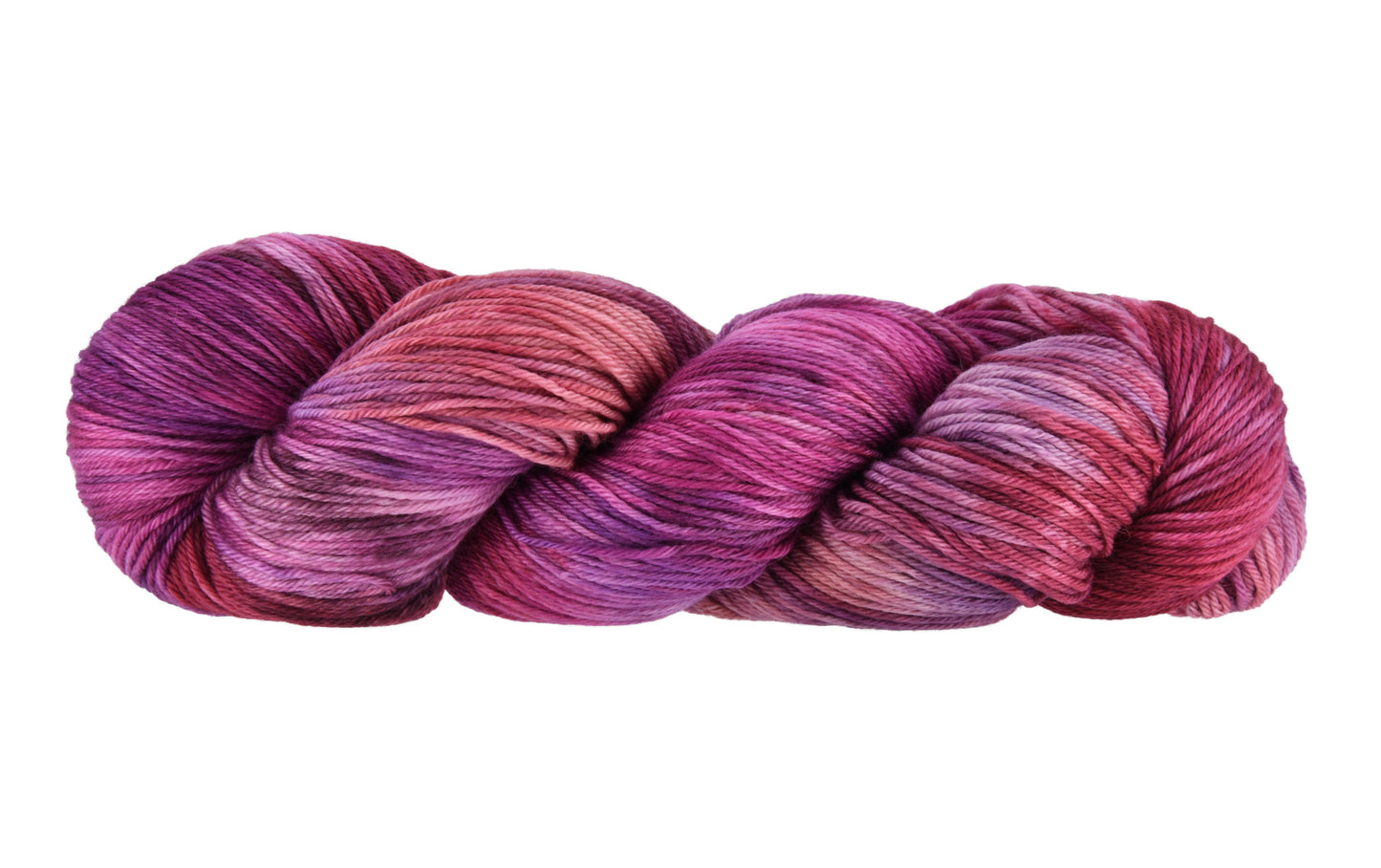 A twisted skein of Barn Yarn hand-dyed merino-cashmere-nylon yarn in colorway Feelin’ Berry Glam! featuring vibrant berry tones with purple, pink, and jewel-like shades, perfect for stylish knitting and crochet projects.
