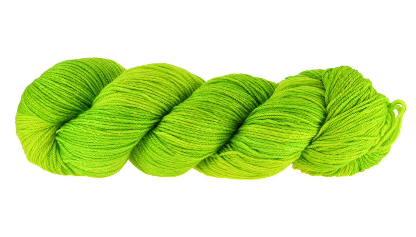 A twisted skein of Barn Yarn hand-dyed merino-cashmere-nylon yarn in colorway Get in Lime - a bold lime green shade, perfect for playful knitting and crochet projects.