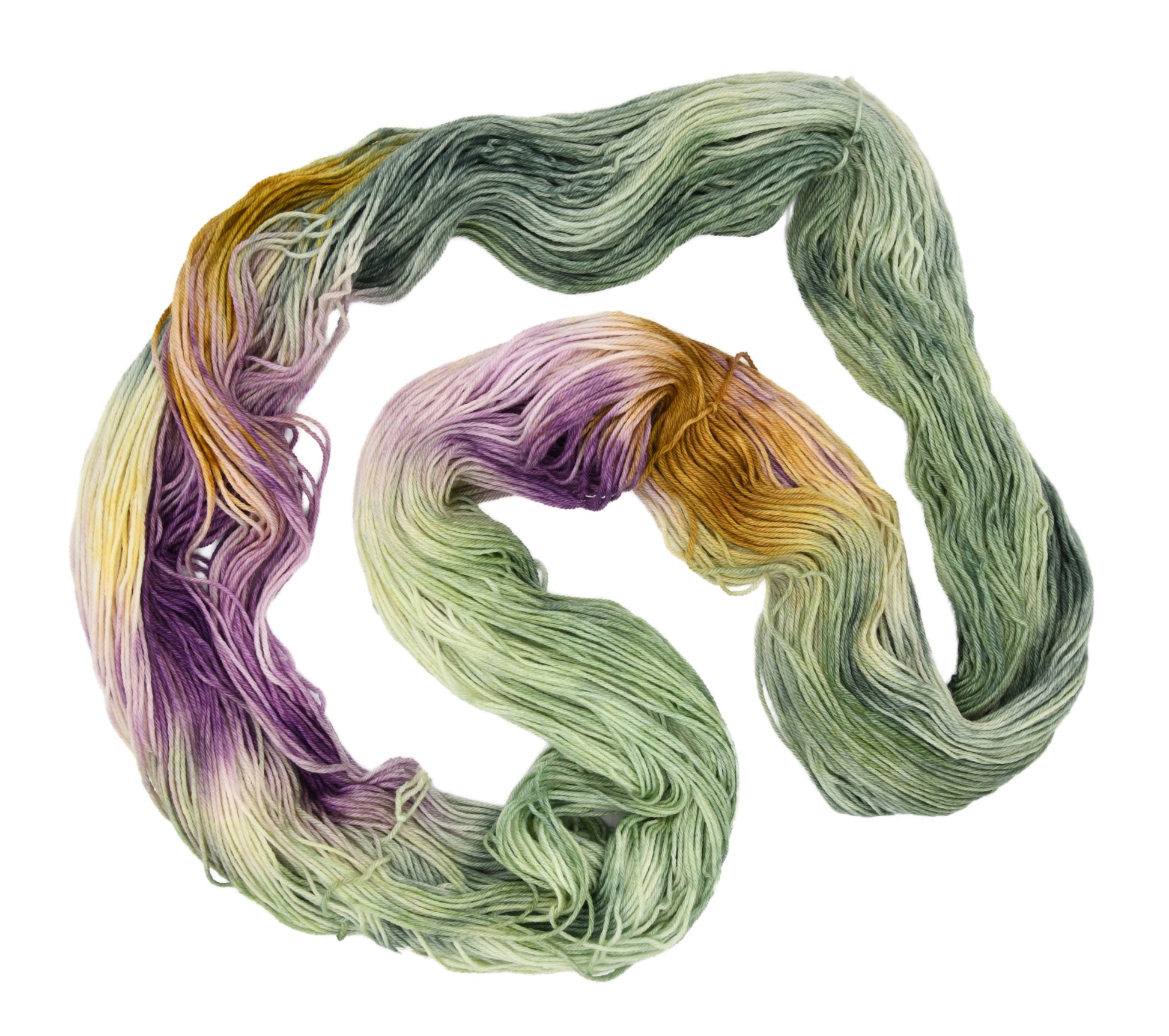 An unfolded skein of Barn Yarn hand-dyed merino-cashmere-nylon yarn in colorway Pistachio, soft green shades with creamy toffee and purple undertones, perfect for fresh and playful knitting and crochet projects.