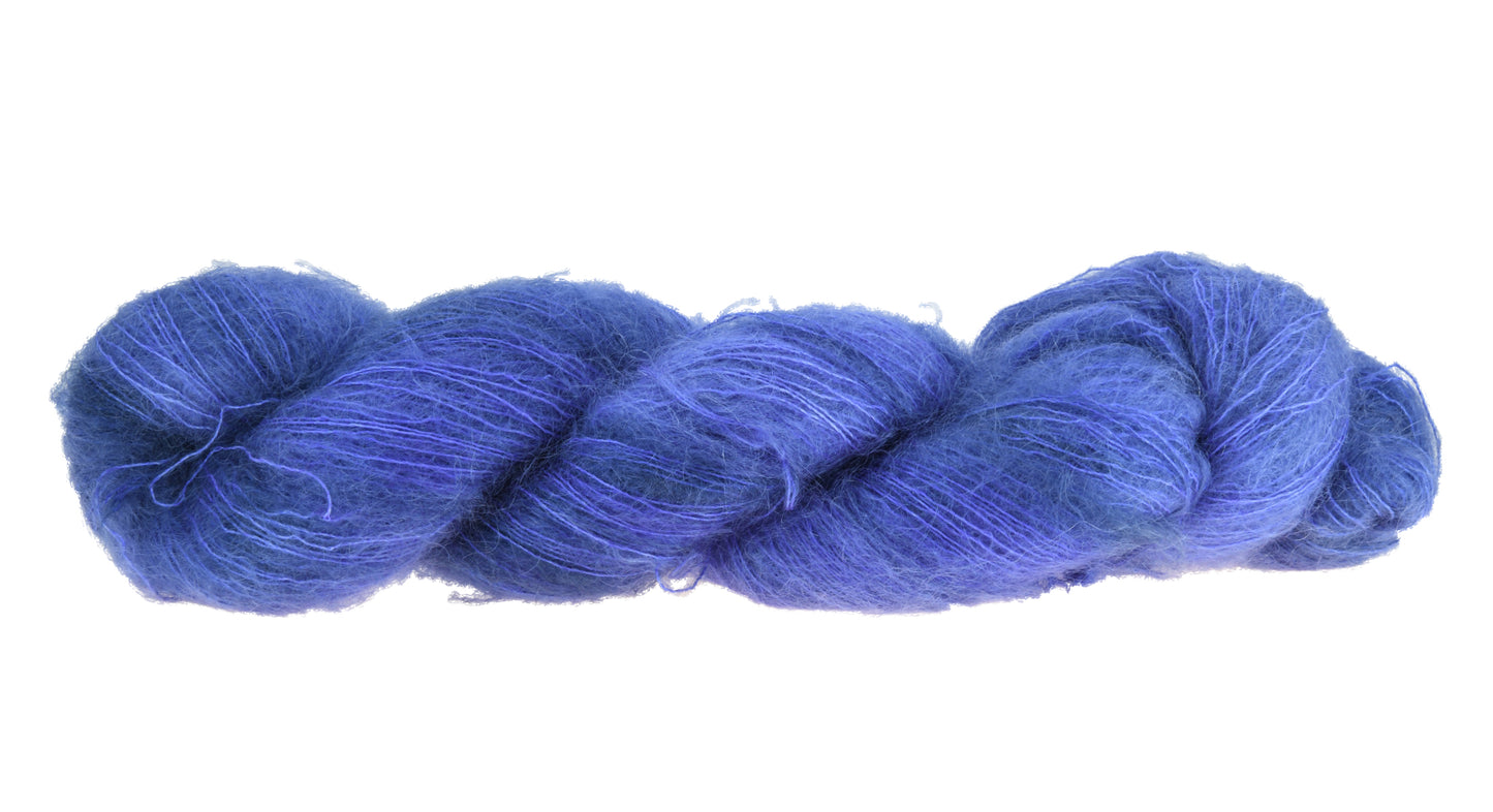 A twisted skein of Barn Yarn mohair yarn in colorway Lavender; inspired by the lavender flower, perfect for knitting and crochet projects.