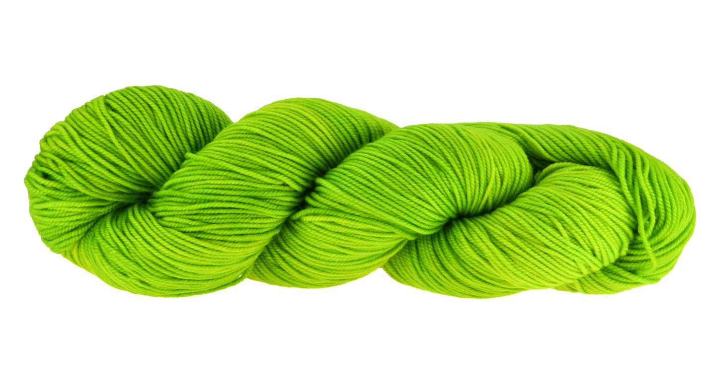 A twisted skein of Barn Yarn hand-dyed sport weight yarn in colorway Get in Lime - a bold lime green shade, perfect for playful knitting and crochet projects.