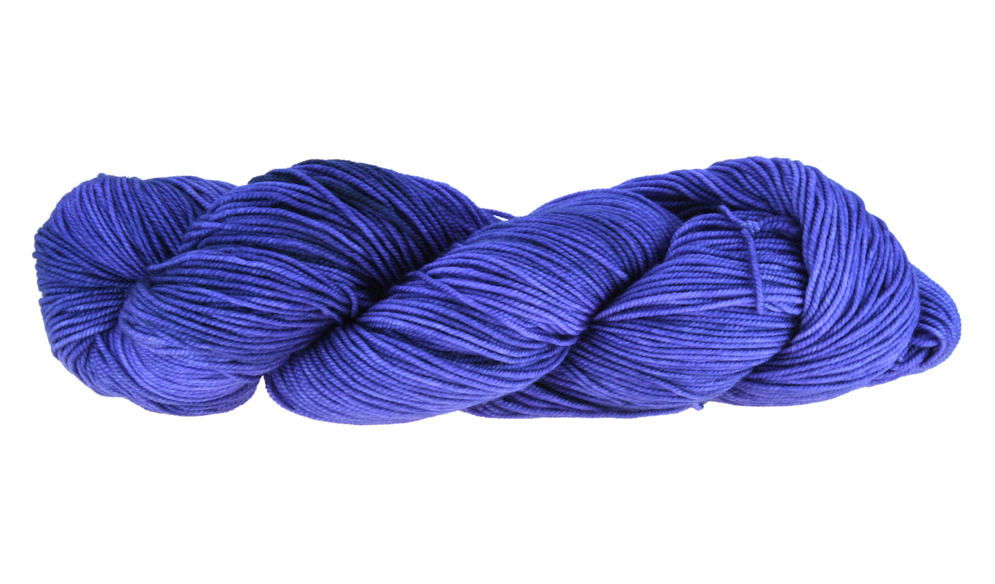 A twisted skein of Barn Yarn sport weight yarn in colorway Lavender; inspired by the lavender flower, perfect for knitting and crochet projects.
