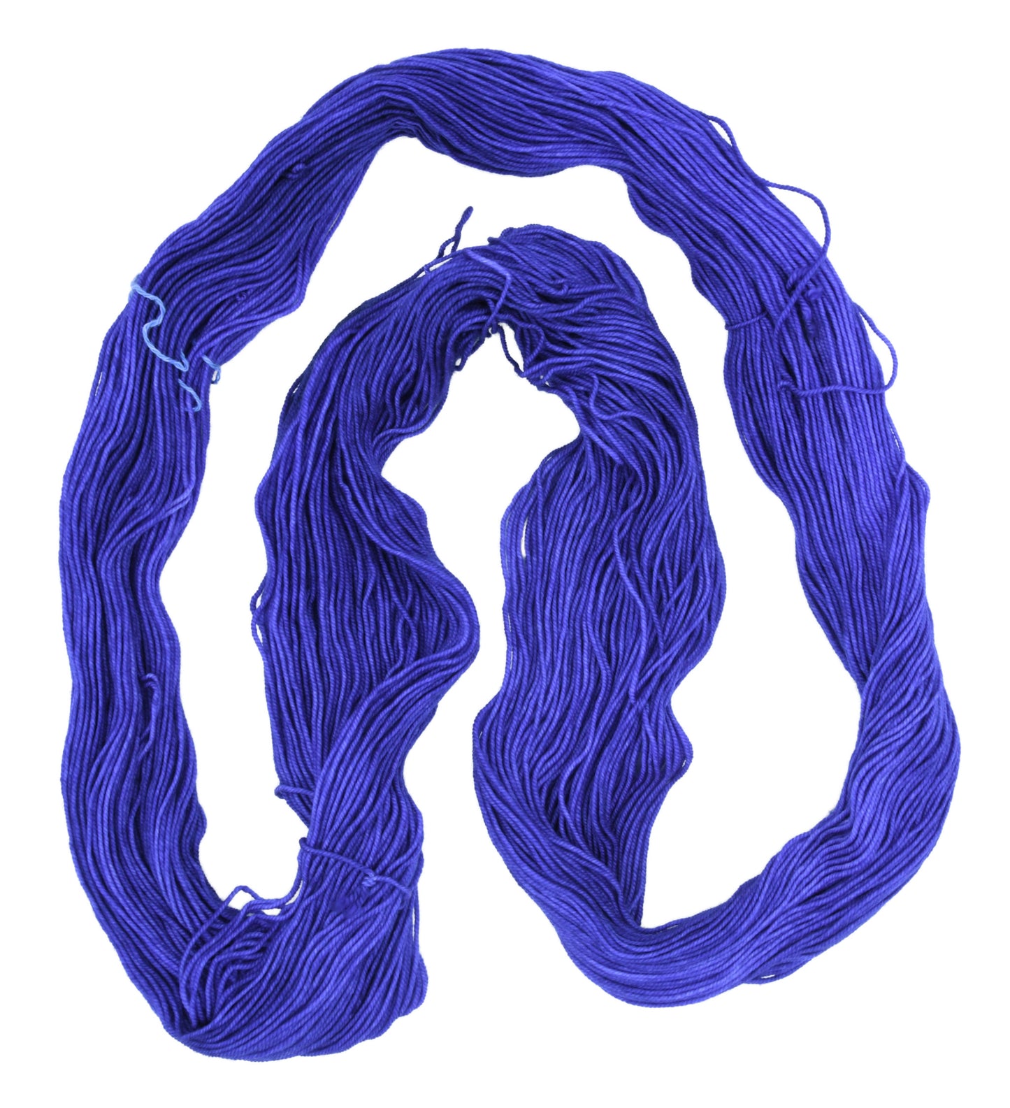 An unfolded skein of Barn Yarn sport weight yarn in colorway Lavender; inspired by the lavender flower, perfect for knitting and crochet projects.
