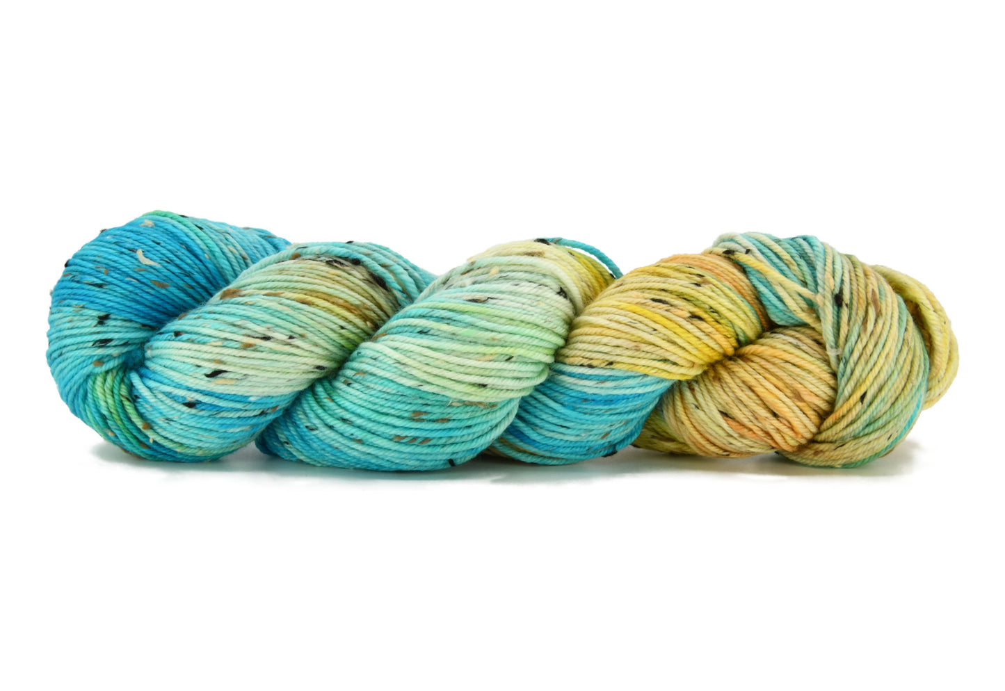 A twisted skein of Barn Yarn hand-dyed tweed DK weight yarn in colorway Down by the Seaside with breezy blues, sandy neutrals, and sea-glass greens, perfect knitting and crochet.