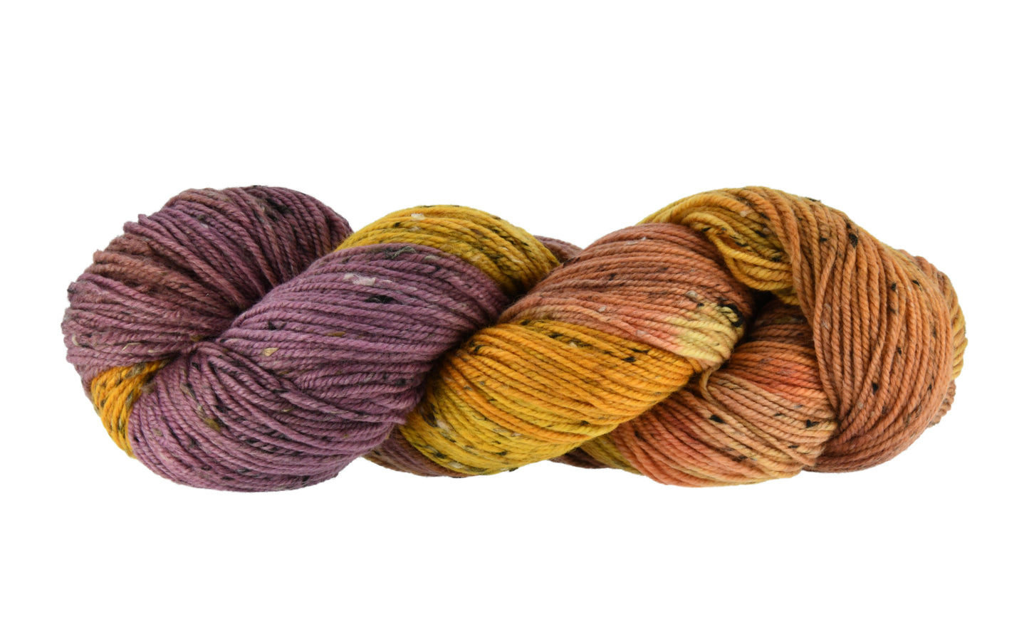 A twisted skein of Barn Yarn hand-dyed tweed DK weight yarn in colorway Fallen Leaves featuring warm autumn tones of brown, gold, red, and green, perfect for cozy knitting and crochet projects.