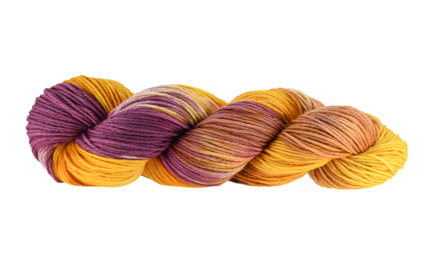 A twisted skein of Barn Yarn hand-dyed worsted weight yarn in colorway Fallen Leaves featuring warm autumn tones of brown, gold, red, and green, perfect for cozy knitting and crochet projects.
