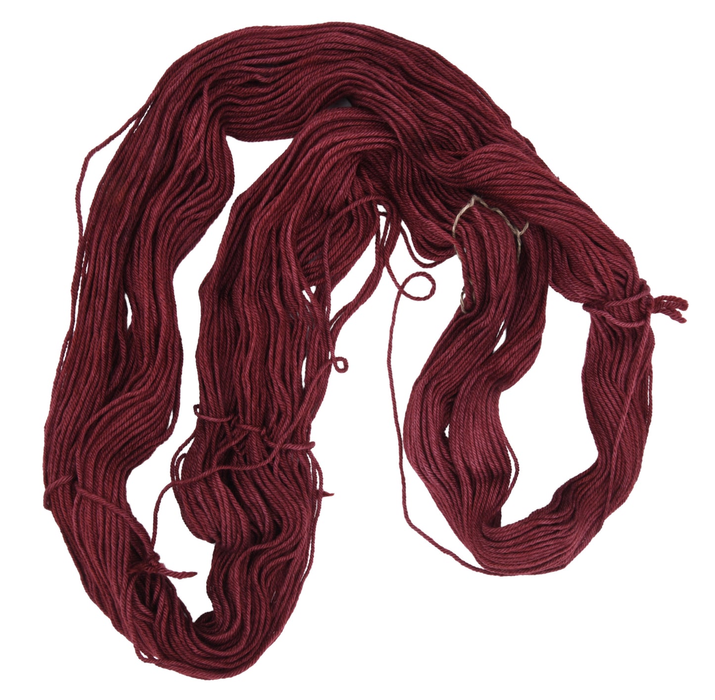An unfolded skein of Barn Yarn hand-dyed worsted weight yarn in colorway Chocolate Moose; a rich, earthy brown shade, perfect for warm and cozy knitting and crochet projects.
