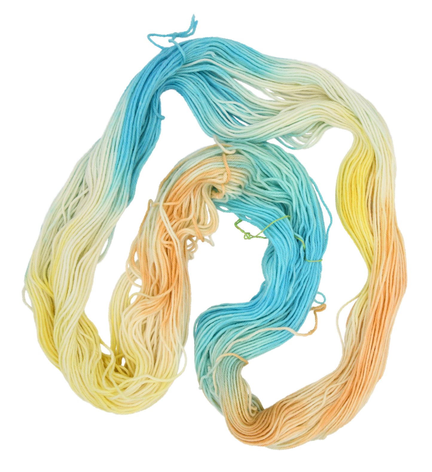 An unfolded skein of Barn Yarn hand-dyed worsted weight yarn in colorway Down by the Seaside with breezy blues, sandy neutrals, and sea-glass greens, perfect knitting and crochet.