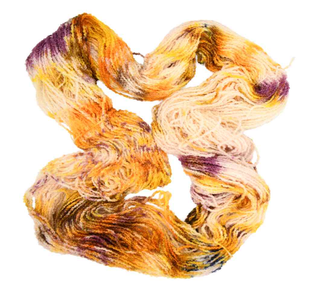 An unfolded skein of Barn Yarn hand-dyed boucle DK yarn in colorway Harvest - golden amber and burnt orange with subtle speckles of brown and cream, perfect for textured knitting and crochet projects.