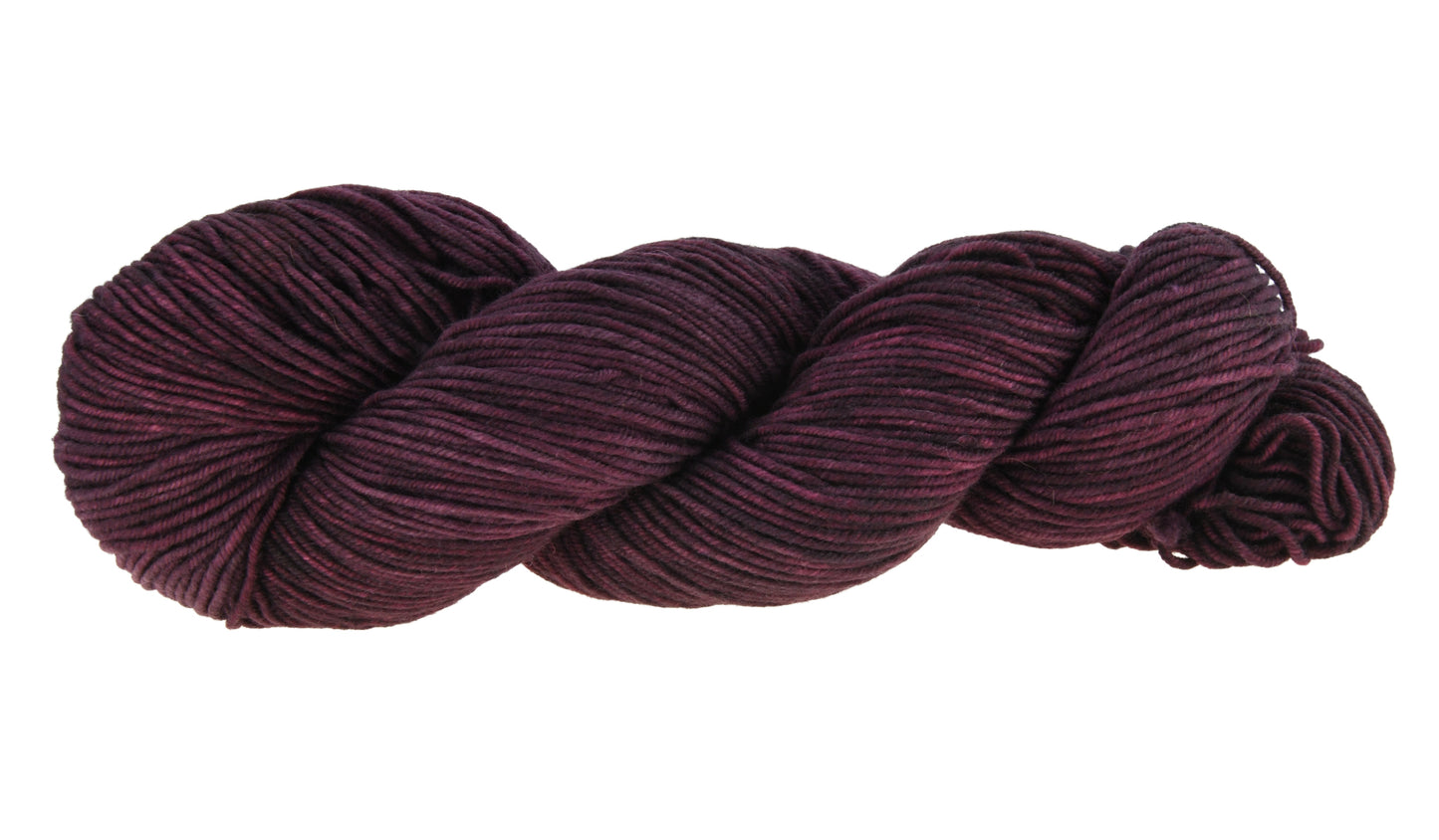 A twisted skein of Barn Yarn hand-dyed DK weight yarn in colorway Plum; a rich, deep purple shade, perfect for sophisticated knitting and crochet projects.