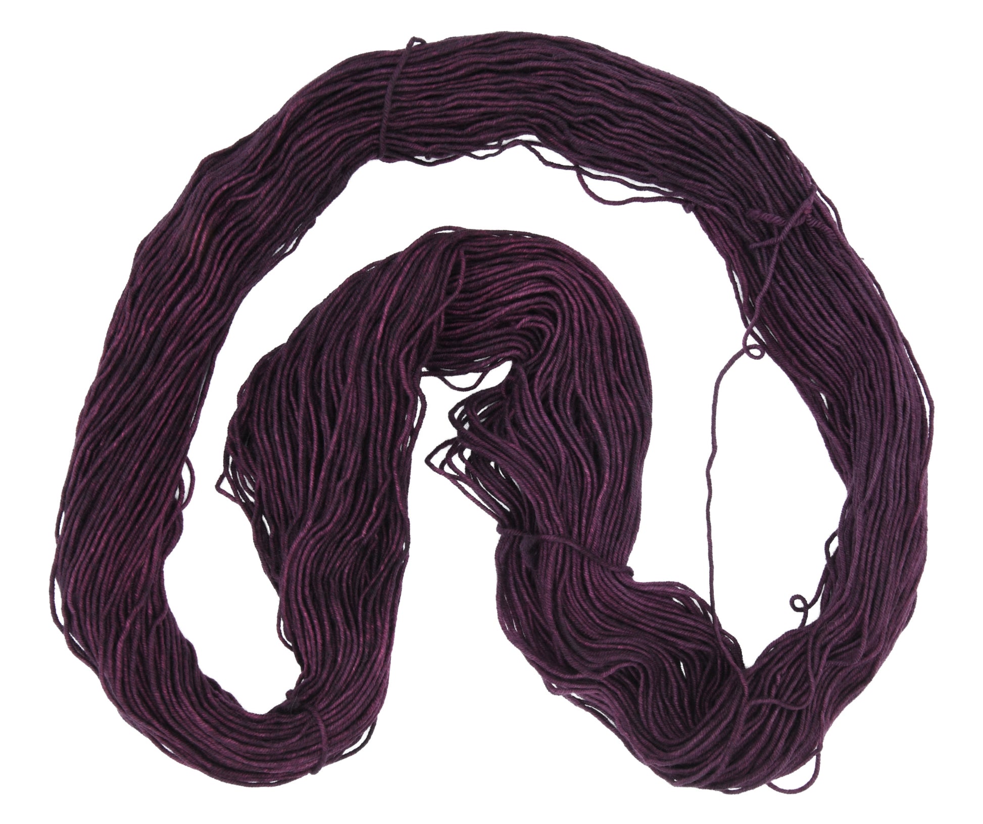 An unfolded skein of Barn Yarn hand-dyed DK weight yarn in colorway Plum; a rich, deep purple shade, perfect for sophisticated knitting and crochet projects.