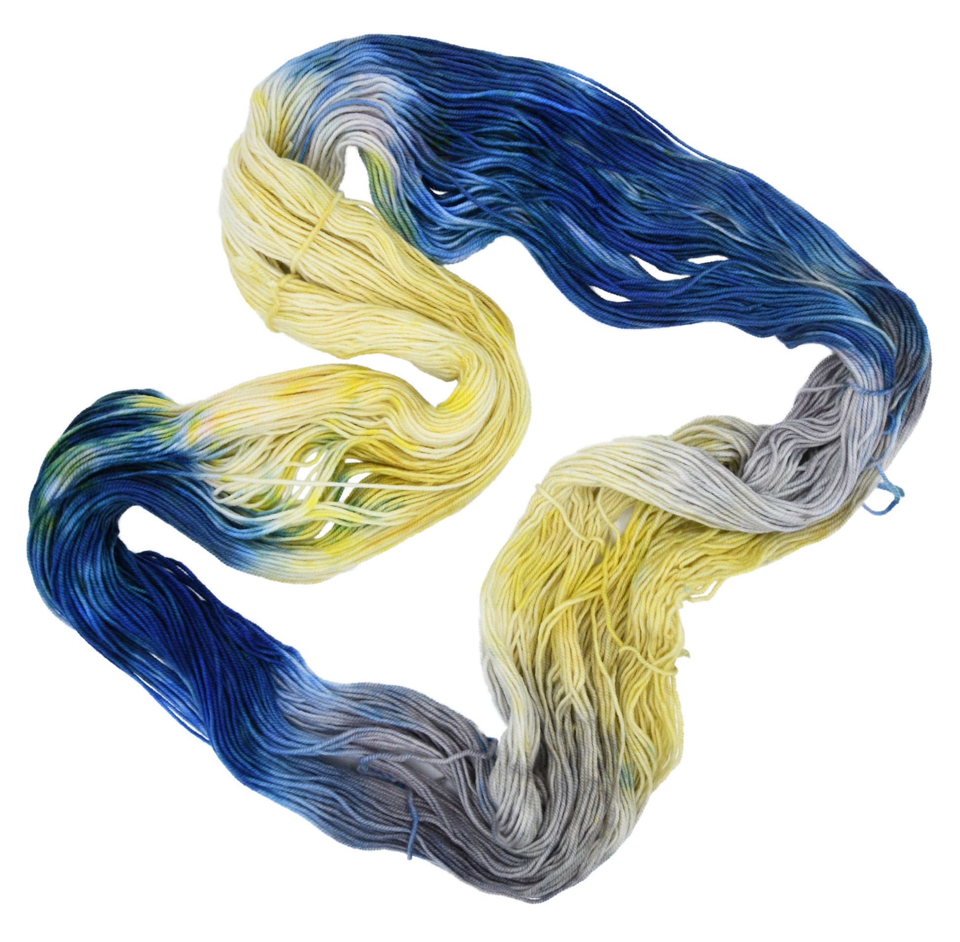 An unfolded skein of Barn Yarn hand-dyed DK weight yarn in colorway Beehive featuring golden yellow, soft gray and blue tones, perfect for warm and vibrant knitting and crochet projects.