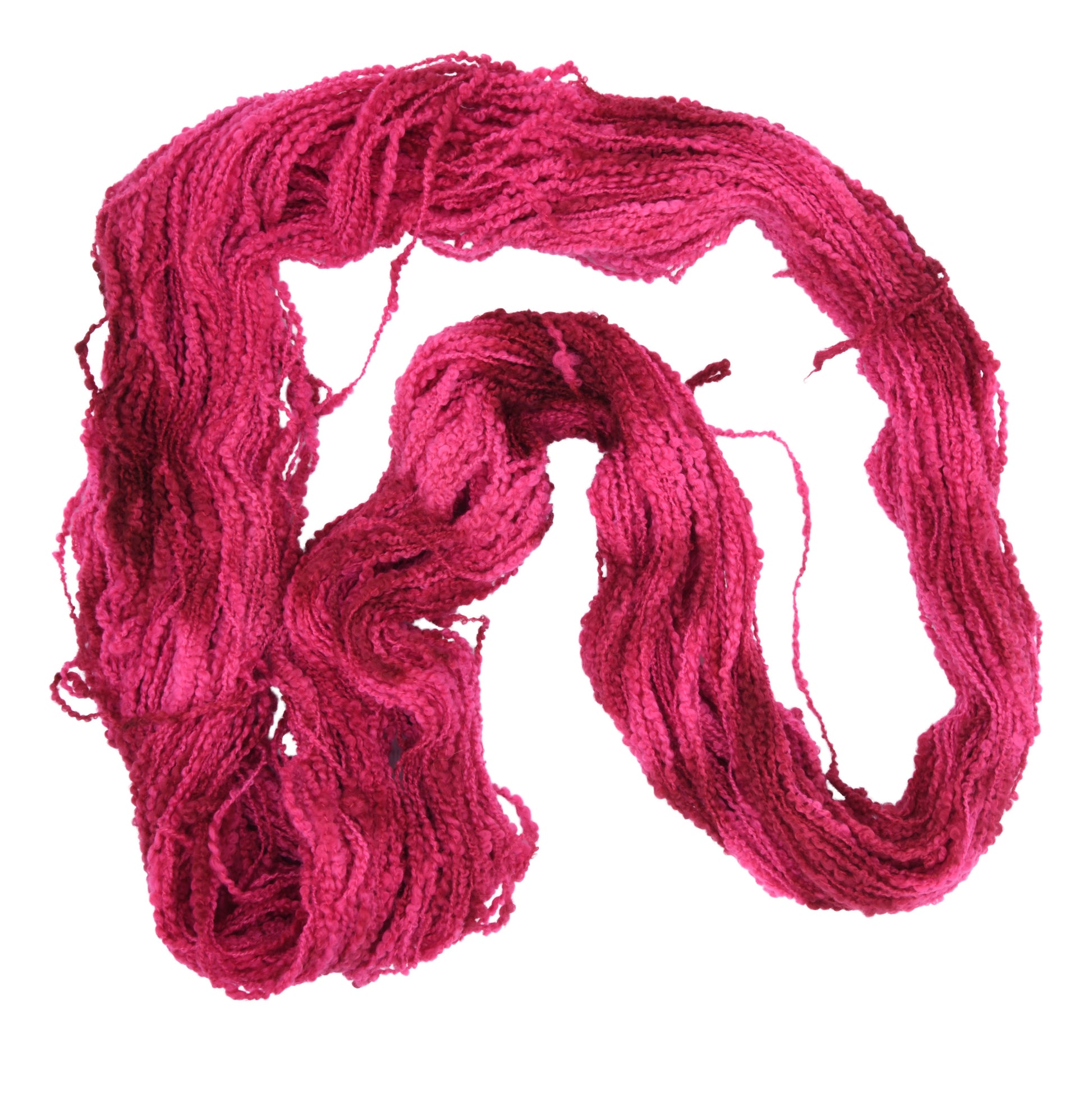 An unfolded hank of Boucle DK weight hand-dyed yarn in colorway Pomegranate featuring layered bright and dark saturated pink tones, ideal for vibrant handmade creations.