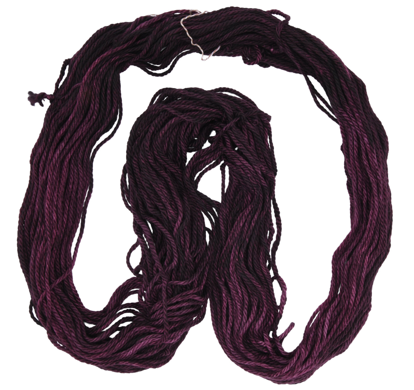 An unfolded skein of Barn Yarn hand-dyed bulky weight yarn in colorway Plum; a rich, deep purple shade, perfect for sophisticated knitting and crochet projects.