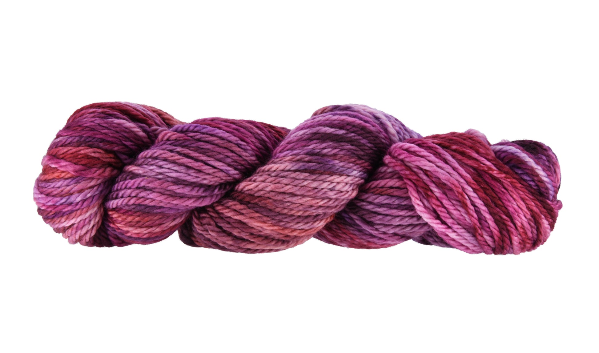 A twisted skein of Barn Yarn hand-dyed bulky weight yarn in colorway Feelin’ Berry Glam! featuring vibrant berry tones with purple, pink, and jewel-like shades, perfect for stylish knitting and crochet projects.
