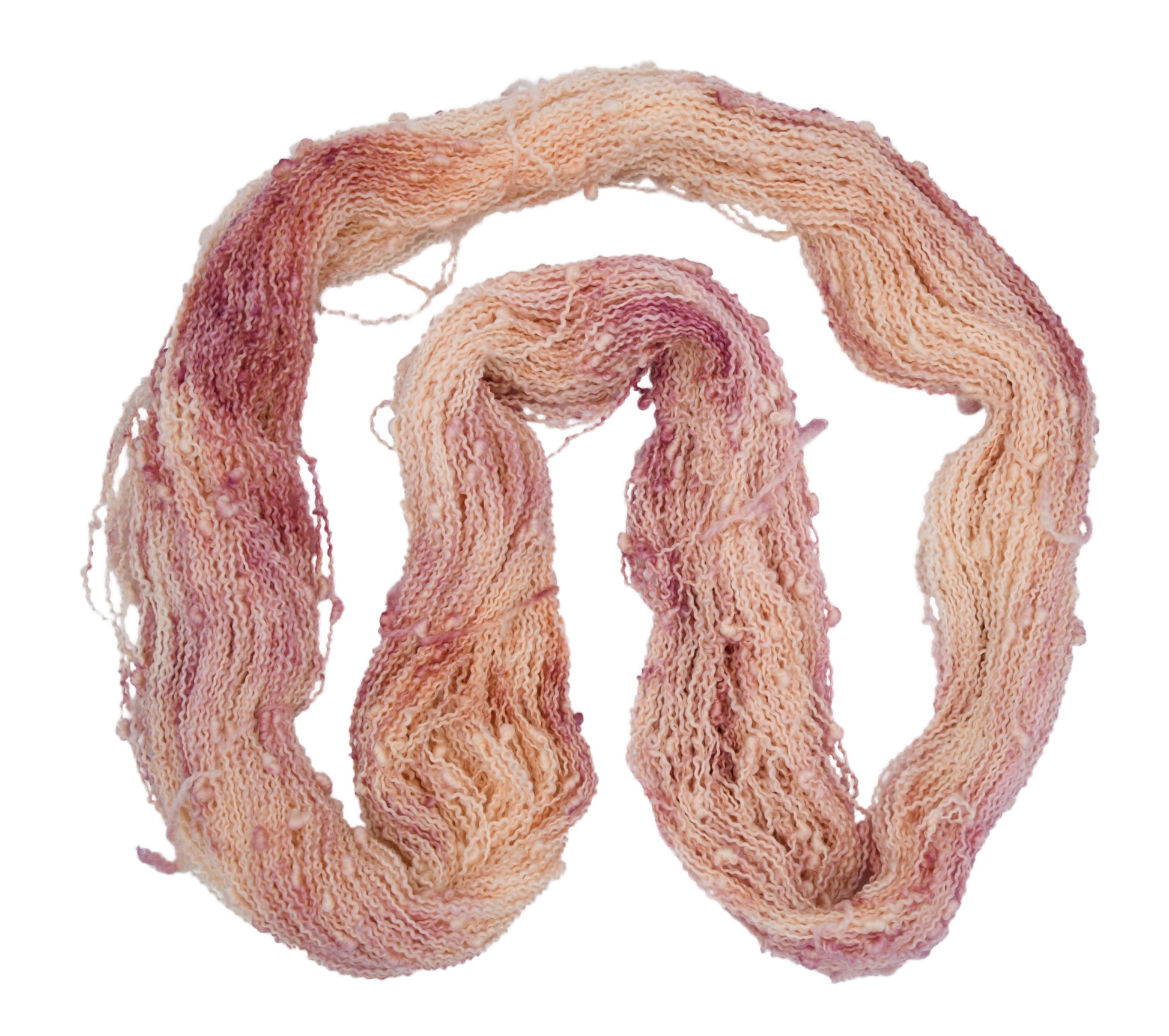 An unfolded skein of Barn Yarn hand-dyed slub yarn in colorway Melrose Place featuring shades of mauve and cream perfect for glamorous knitting and crochet projects.