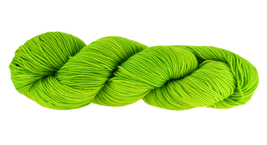 A twisted skein of Barn Yarn hand-dyed sport weight yarn in colorway Get in Lime - a bold lime green shade, perfect for playful knitting and crochet projects.