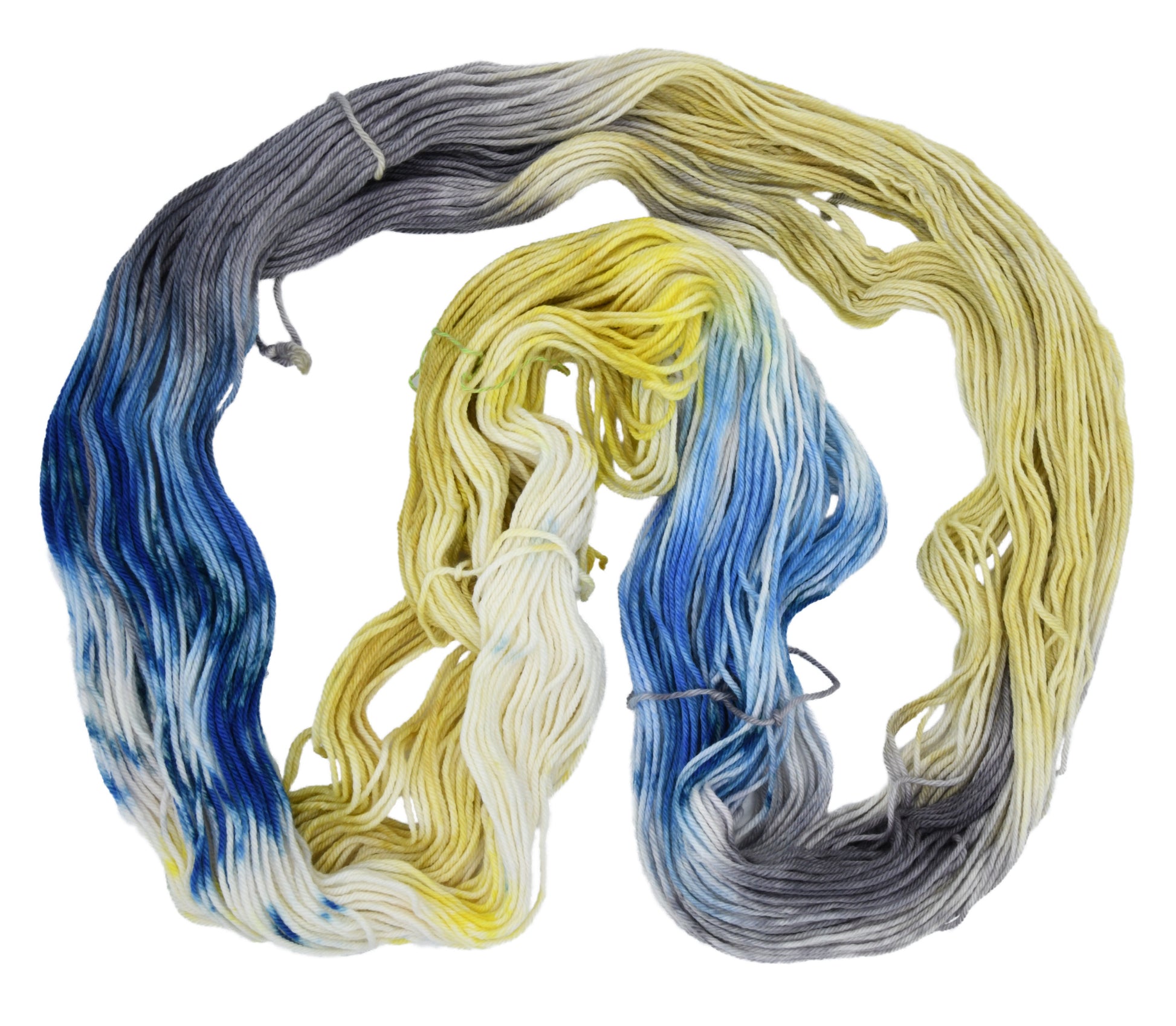 An unfolded skein of Barn Yarn hand-dyed worsted weight yarn in colorway Beehive featuring golden yellow, soft gray and blue tones, perfect for warm and vibrant knitting and crochet projects.