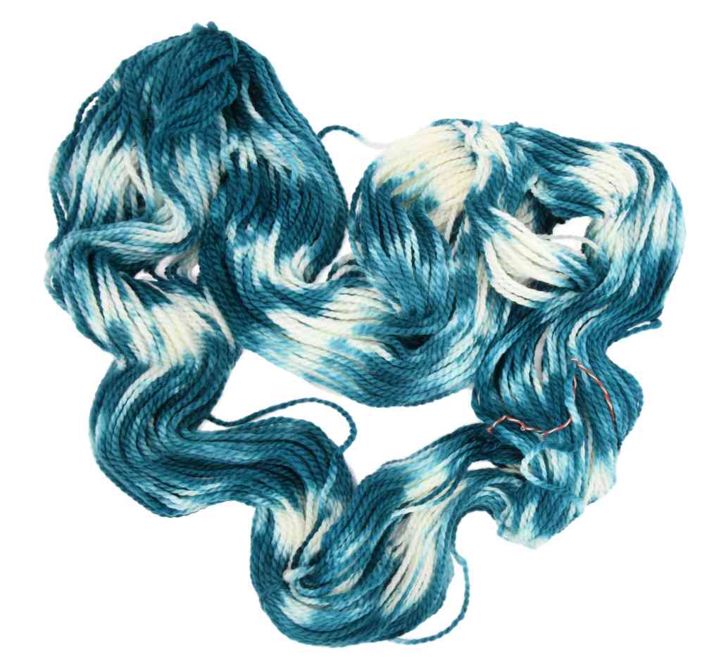 An unfolded skein of Barn Yarn hand-dyed bulky weight yarn in colorway Verdigris - rich teal-green tones with cream, perfect for knitting and crochet projects.