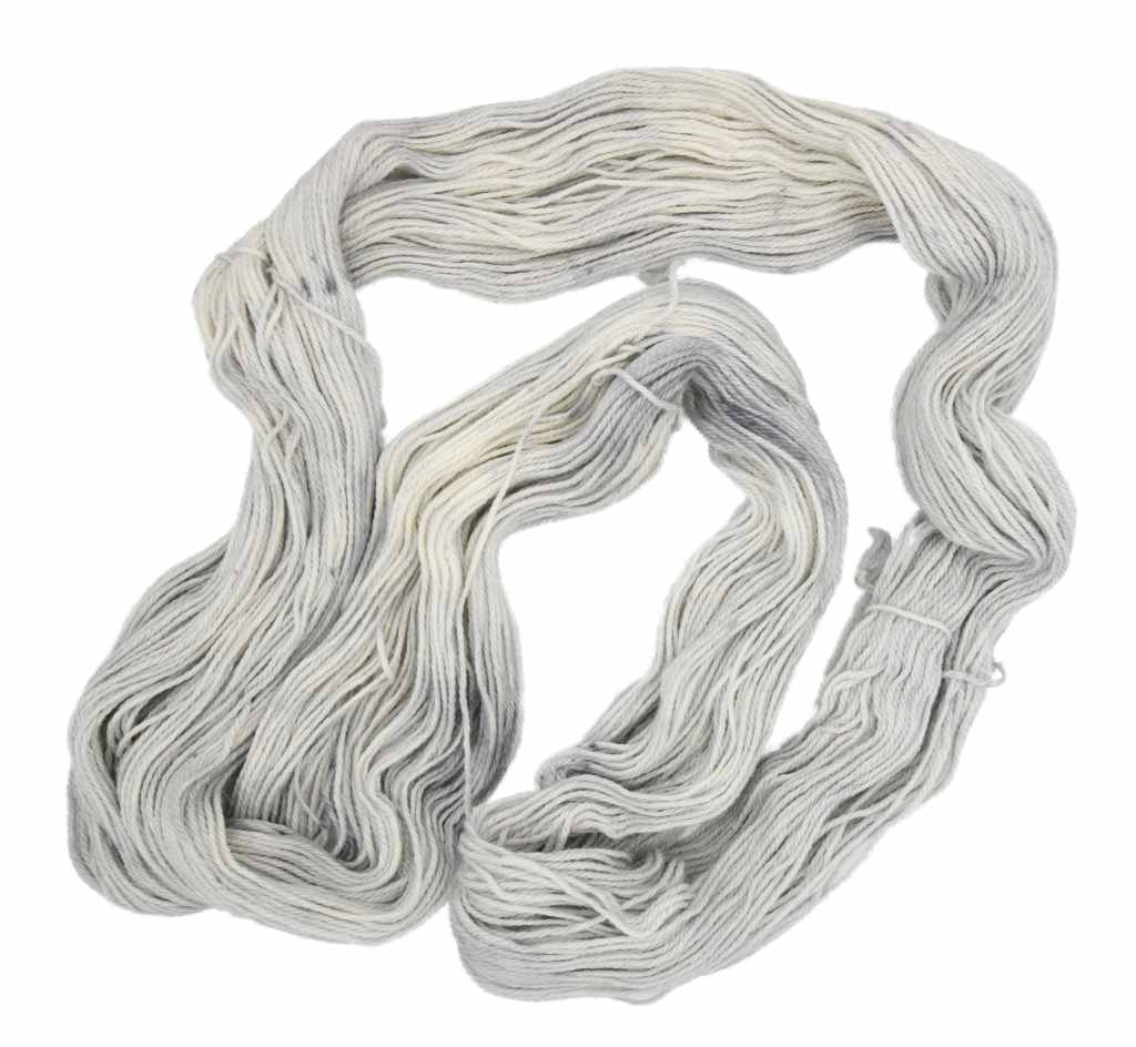 An unfolded skein of Barn Yarn hand-dyed sport weight alpaca yarn in colorway Silver Bells -silvery-gray tones, perfect for soft and elegant knitting or crochet projects. 